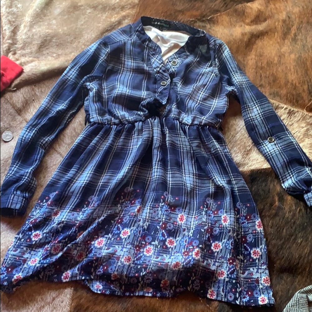 A dark blue plad dress with flowers at the bottom